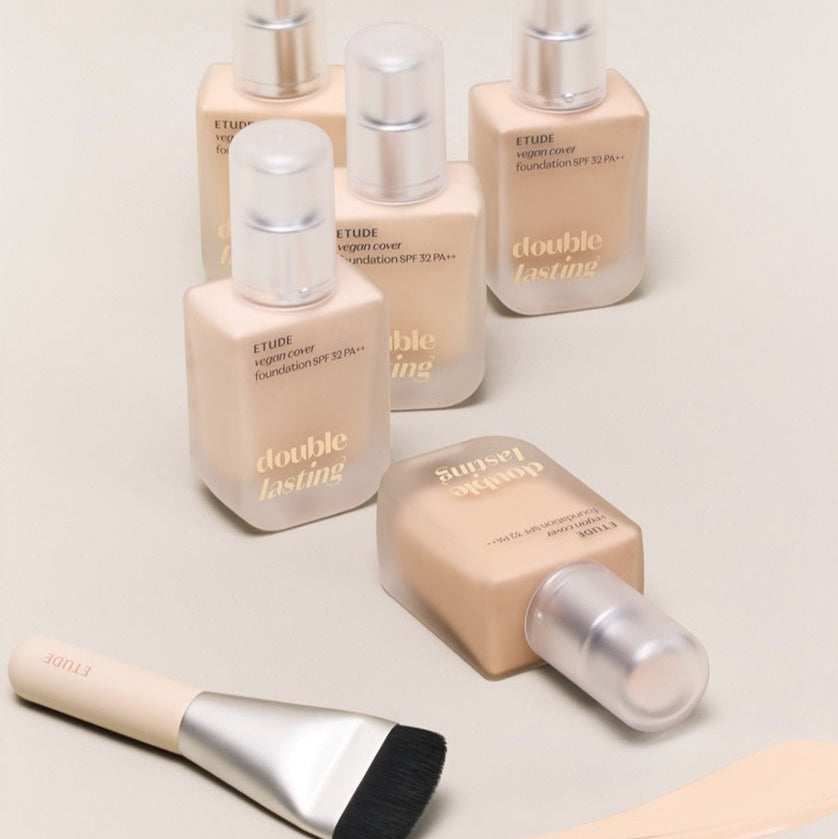 ETUDE Double Lasting Vegan Cover Foundation 30g bottles with brush on a beige background