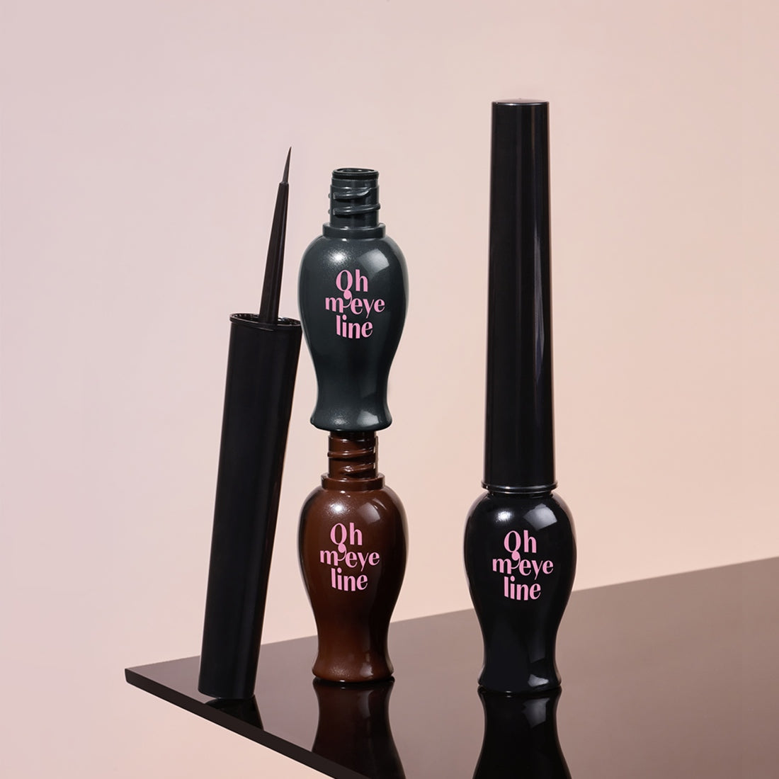 ETUDE Oh My Line liquid eyeliner bottles in black and brown on a reflective surface.
