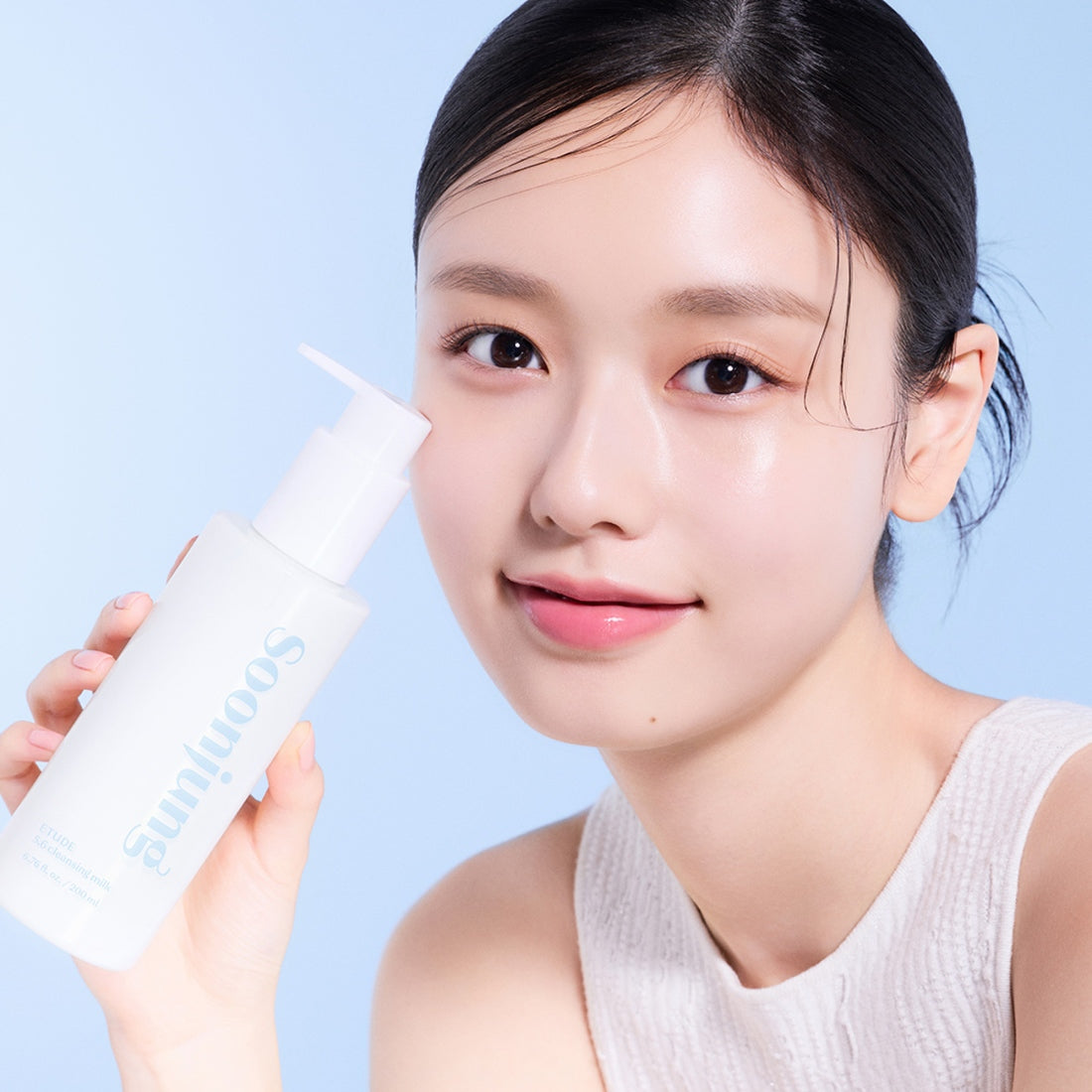 Woman holding ETUDE Pure Mildly Acidic Cleansing Milk 200ml in clean beauty skincare routine