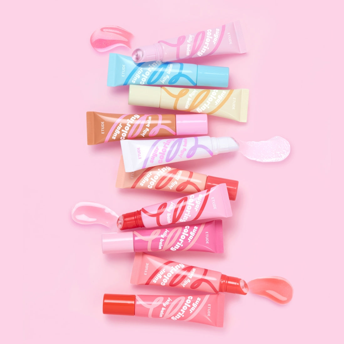 Assorted colors of ETUDE Sugar Coloring Jelly Balm 9g tubes on pink background