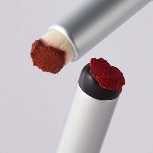 Close-up of FWEE Fingerlike Lip Brush with red pigment and applicator tip