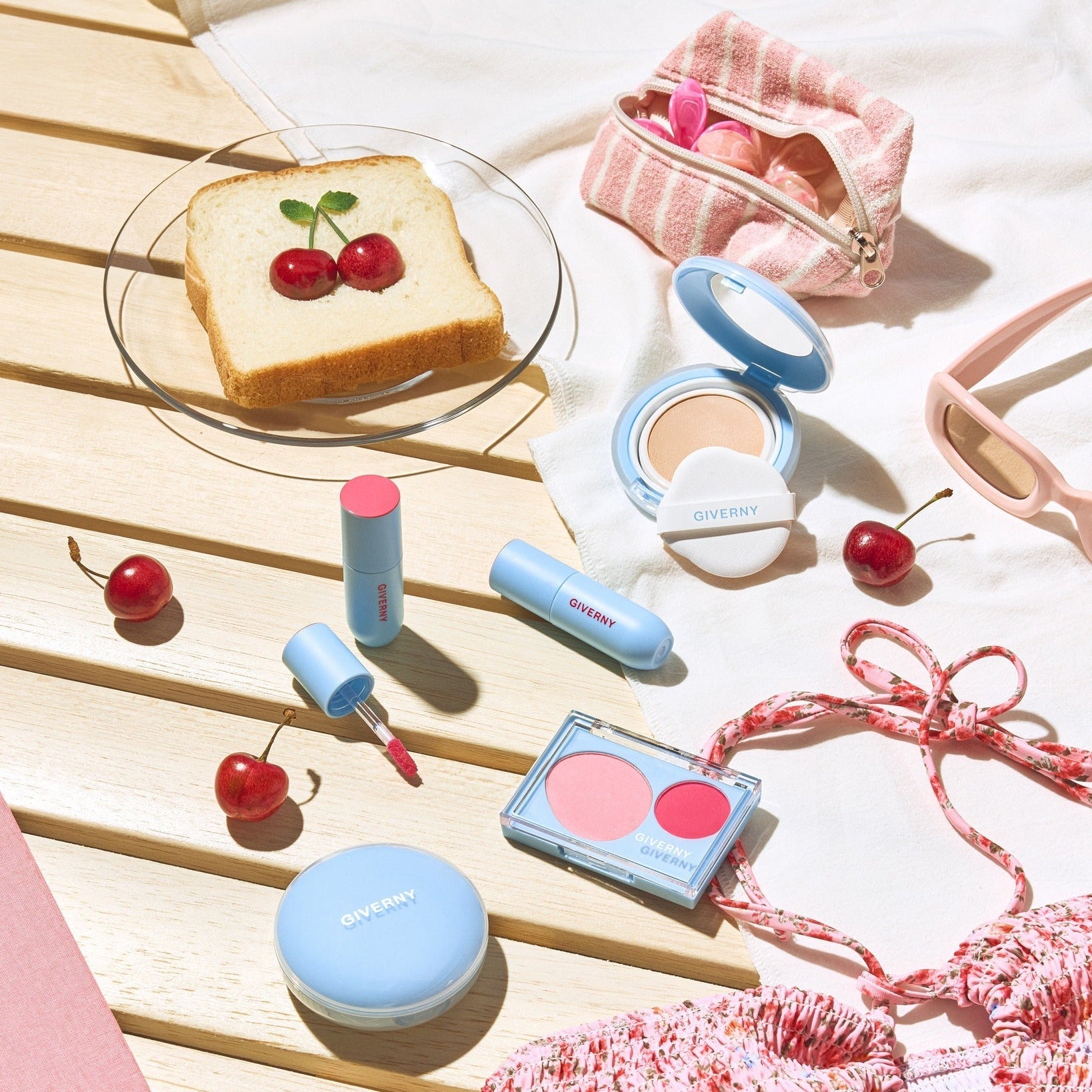 GIVERNY Fluffy Sheer Tint 3.5g displayed on a wooden surface with cherries and makeup items