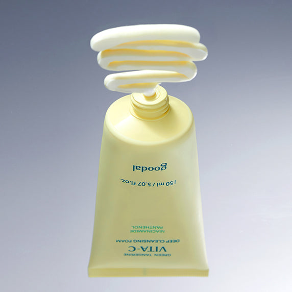GOODAL Green Tangerine Vita C Deep Cleansing Foam 150ml with product squeezed out showing texture on a grey background.