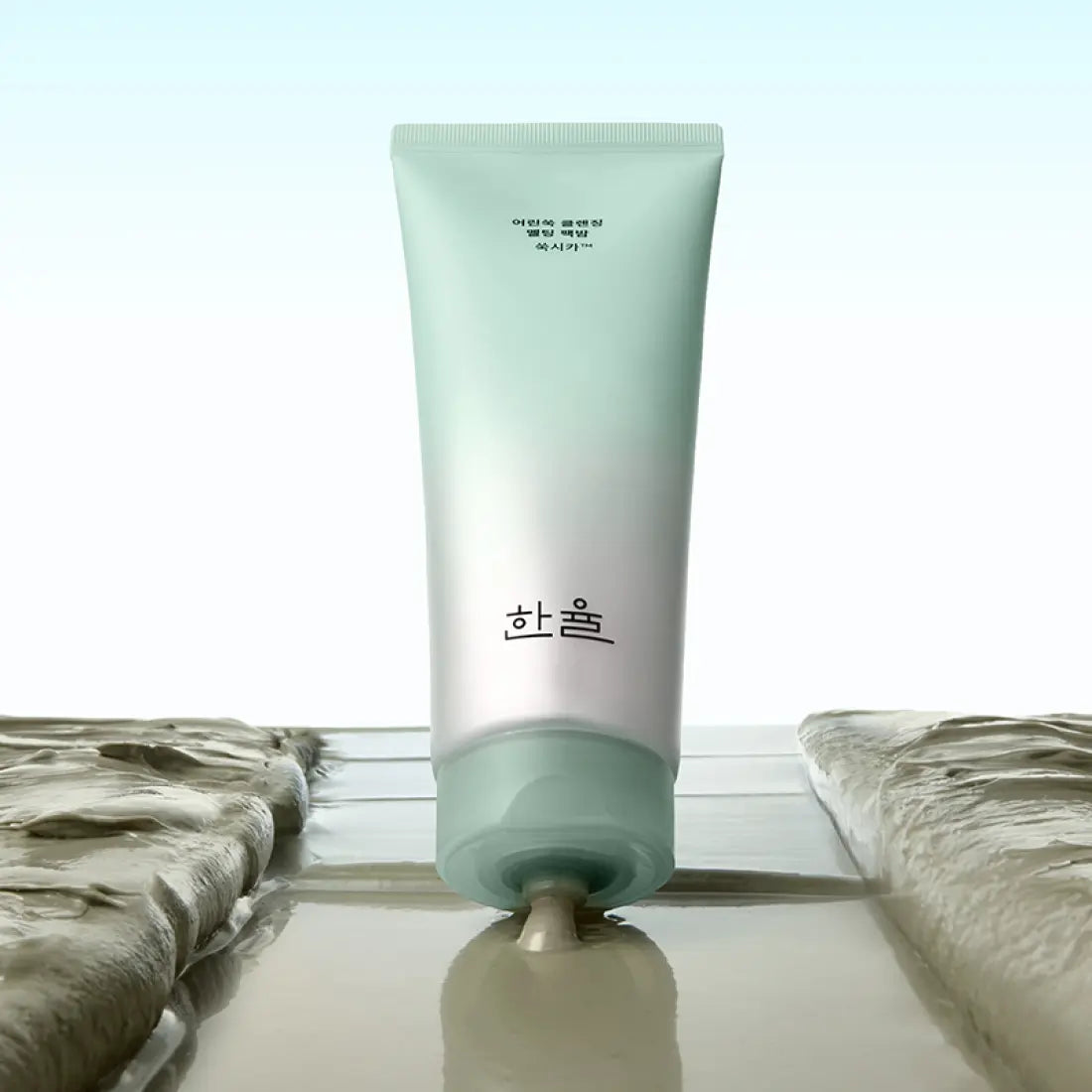 HANYUL Young Artemisia Cleansing Pack Balm 100g tube shown against a light background, highlighting the product texture and packaging.