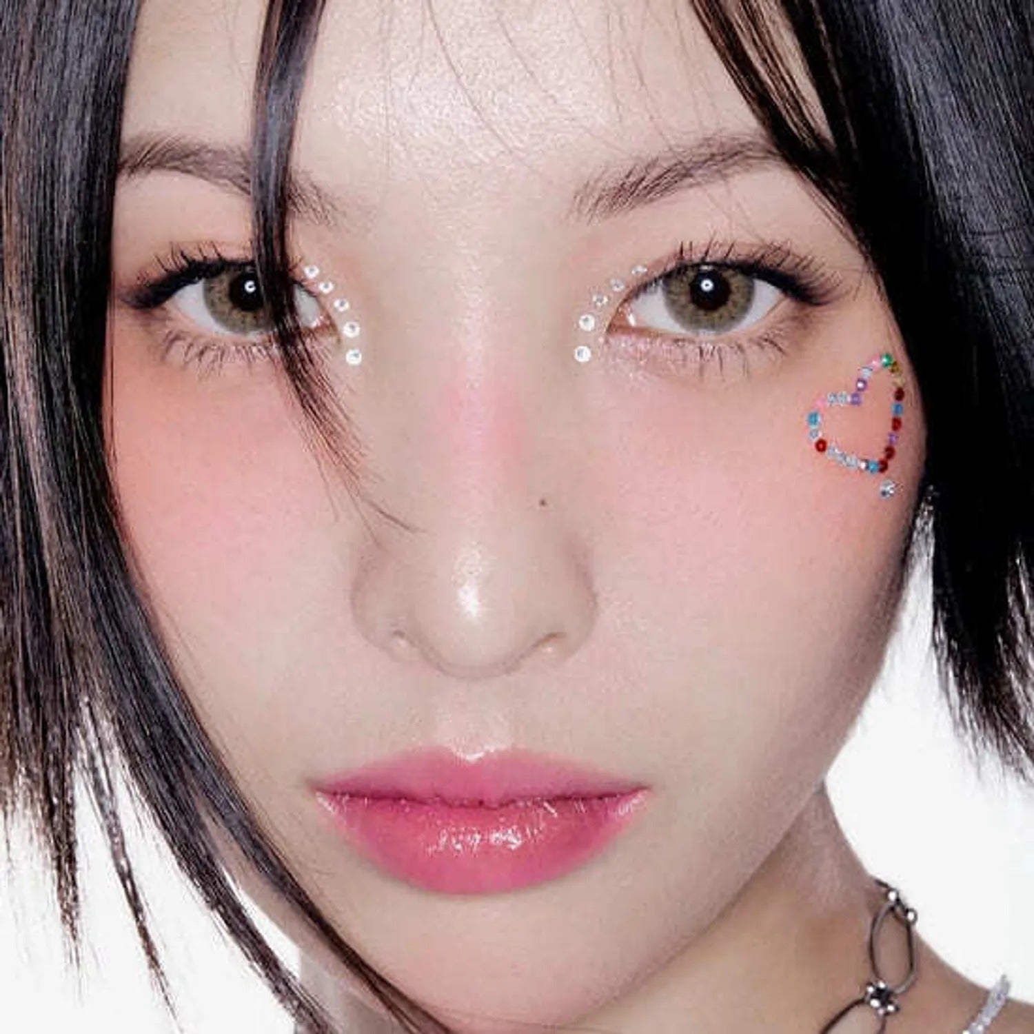 Close-up of model with decorative face gems and soft makeup highlighting HERA Sensual Fiting Glow Tint 5g lip tint.