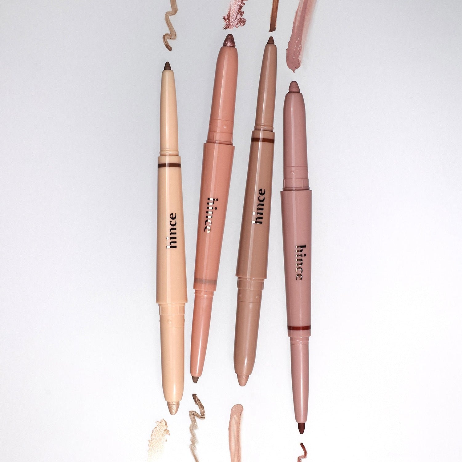Four HINCE Depth Dual Color Stick makeup pencils in assorted shades with visible strokes on white background