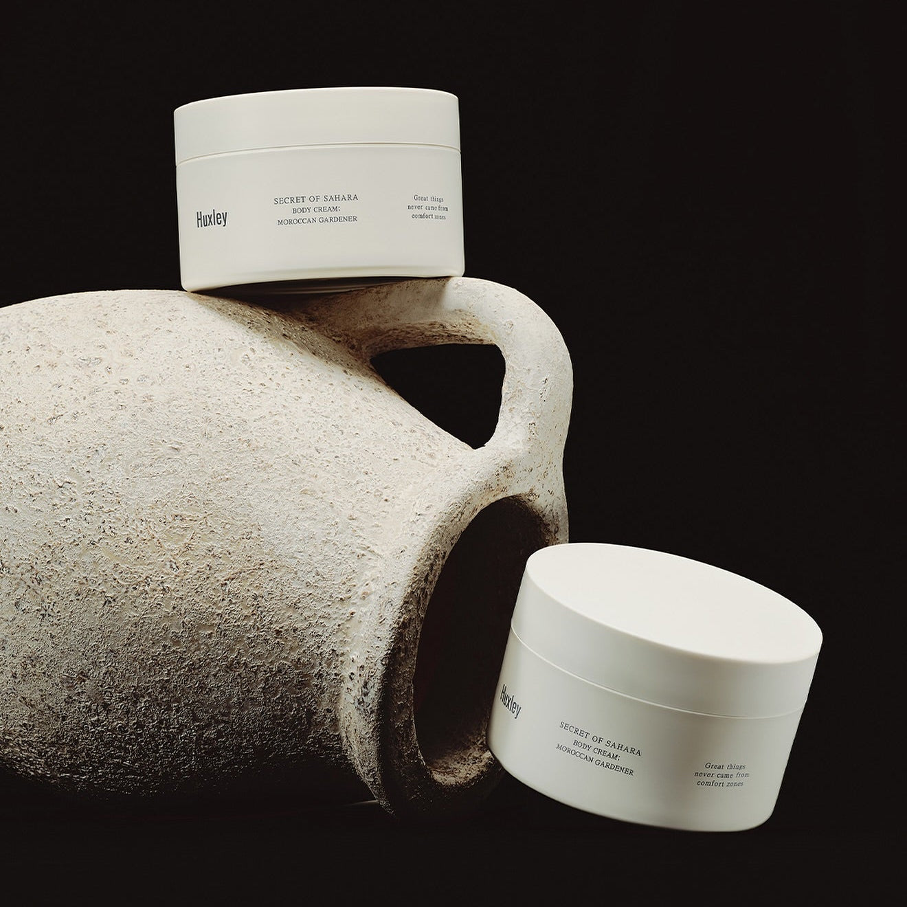 HUXLEY Moroccan Gardener Body Cream 200ml jars displayed with rustic pottery