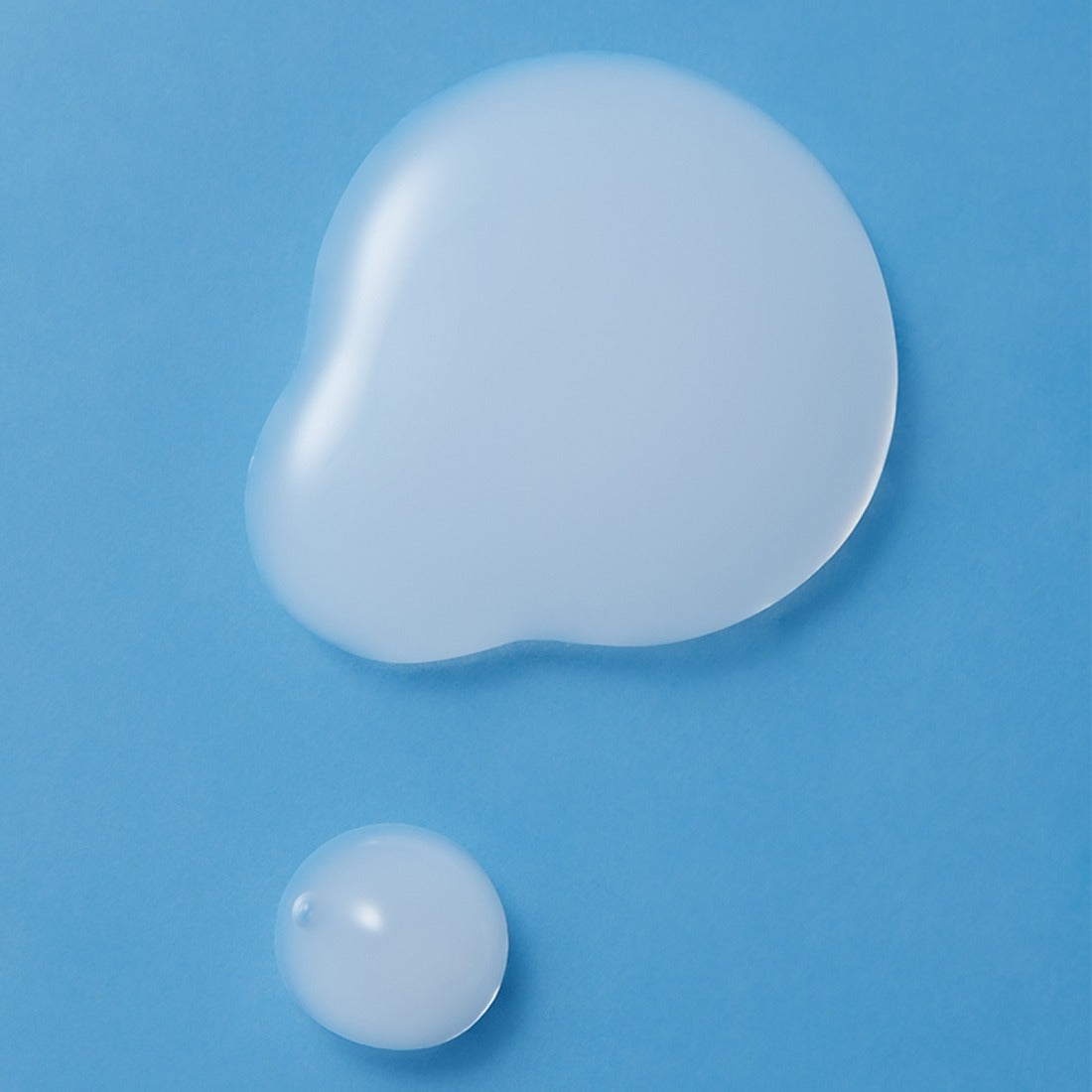 Texture of ILLIYOON Ceramide Ato Moisturizing Skin 250ml on blue background, showcasing its smooth and hydrating properties.