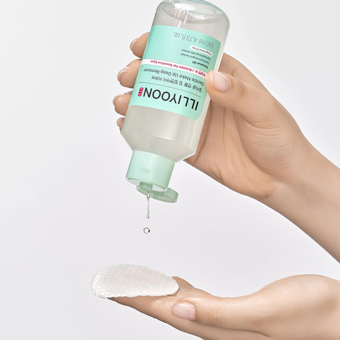 ILLiYOON Gentle Deep Lip & Eye Remover 140ml being poured onto a cotton pad.
