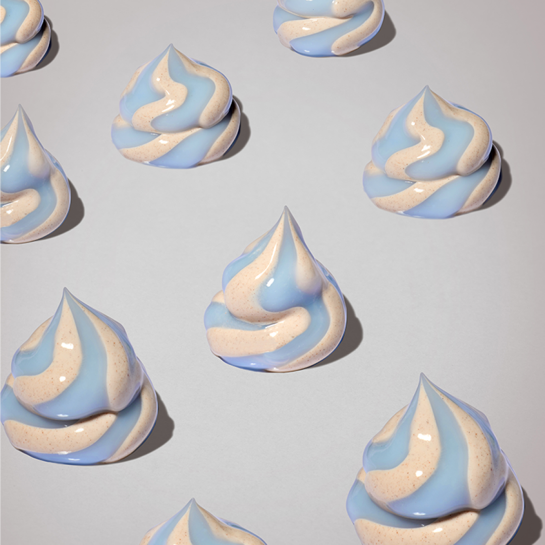 Light blue and beige meringue-like swirls on a gray background