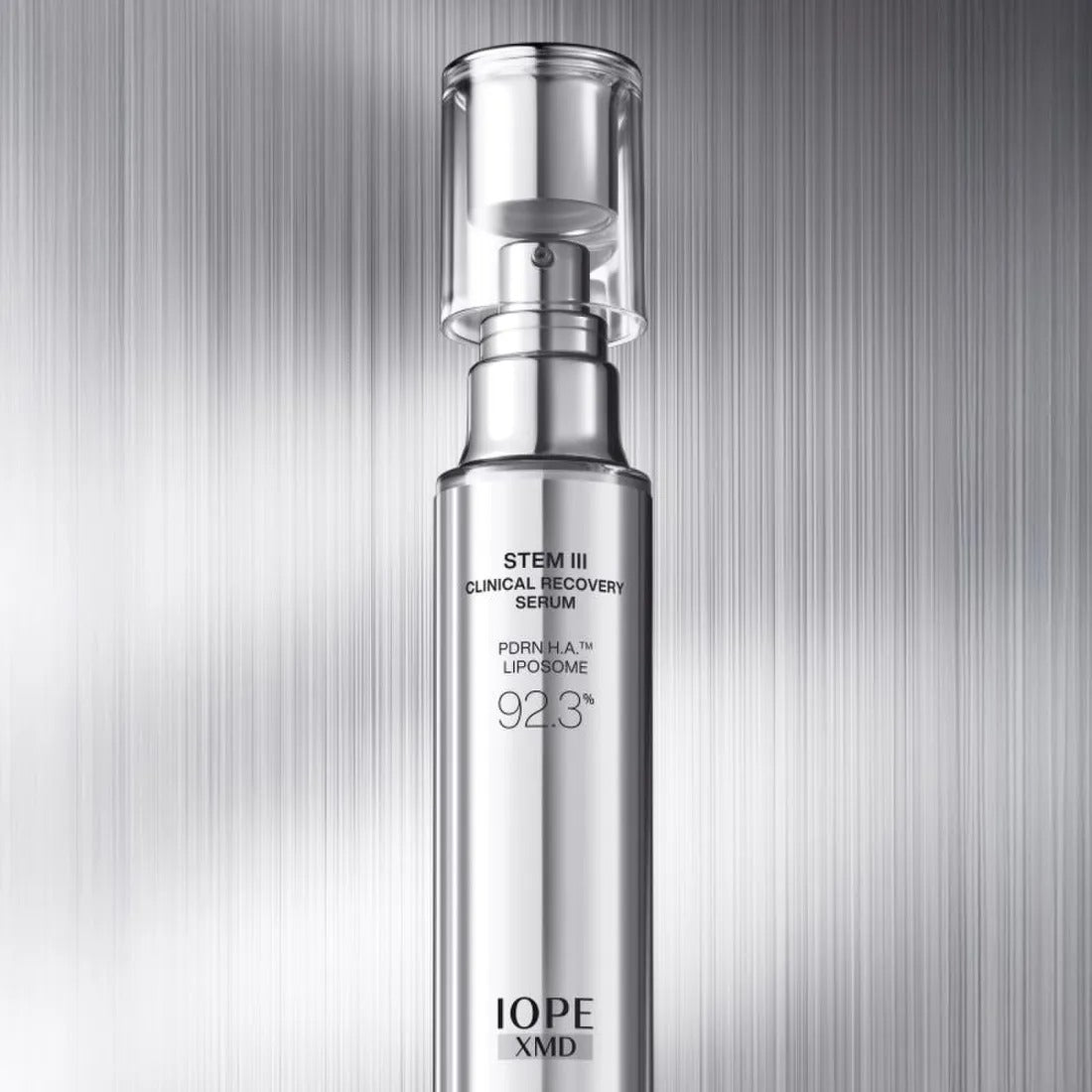 IOPE XMD Stem3 Clinic Recoery Serum 50ml bottle against metallic background