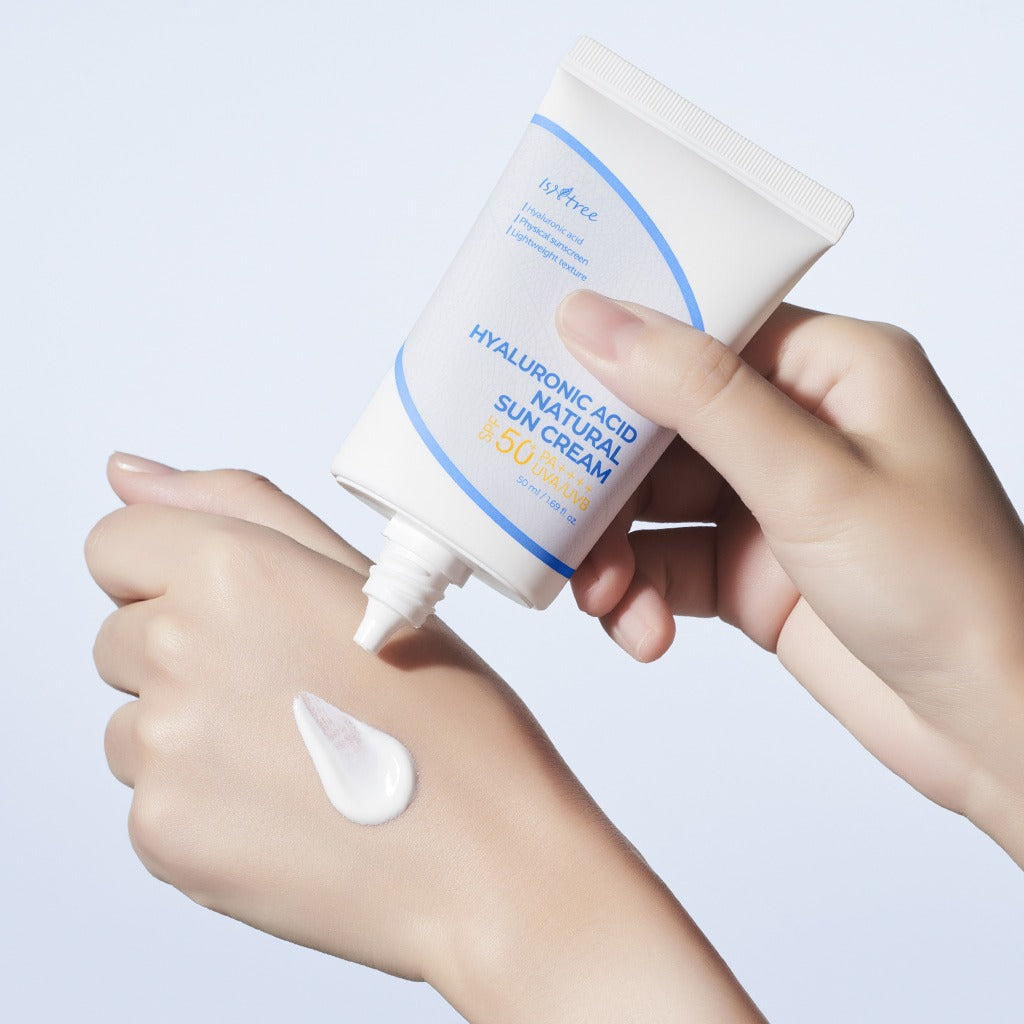 Applying ISNTREE Hyaluronic Acid Batural Sunscreen 50ml on skin for sun protection and hydration.
