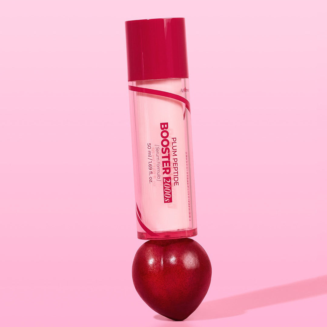 ISNTREE Plum Peptide Booster 2000s 50ml standing on a plum on a pink background