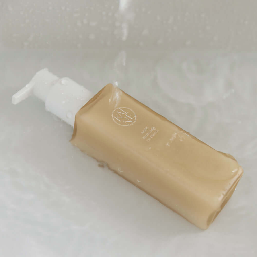 KAINE Kombu Jelly Oil Cleanser 145ml bottle in water, highlighting its luxurious formula and packaging.