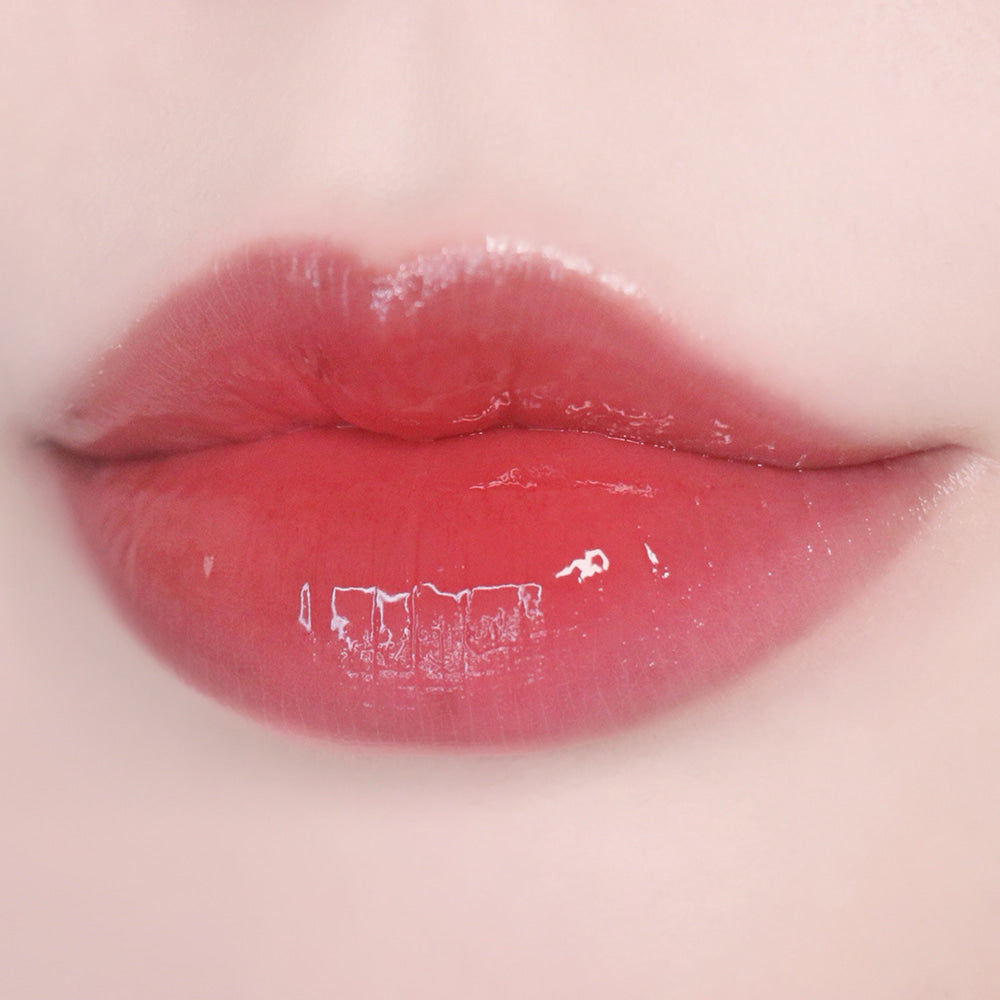 Lips wearing KEEP IN TOUCH Glow Water Lip Tint in a glossy finish.