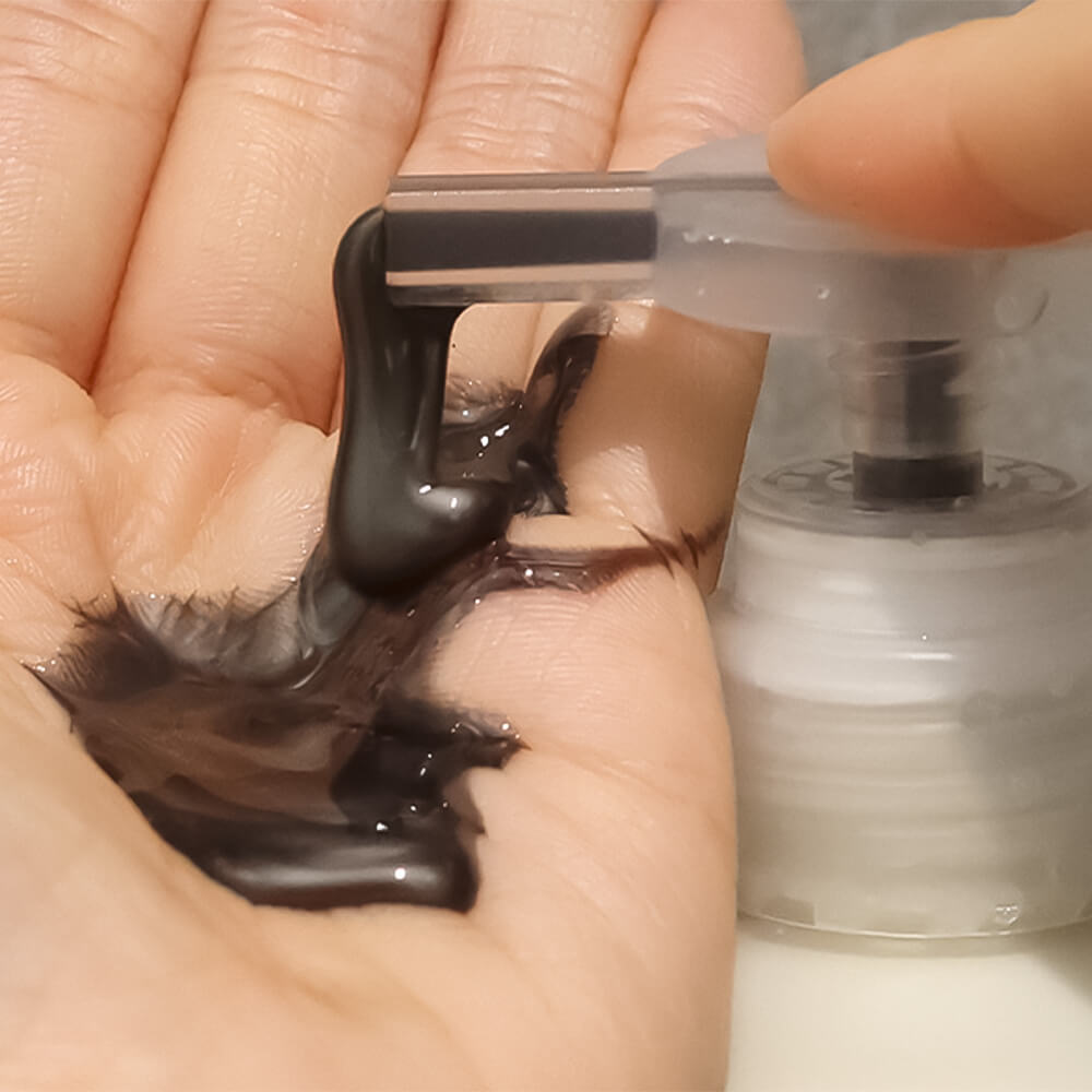 Applying LADOR ASH Silver Shampoo 300ml in hand, showcasing texture and color of the product