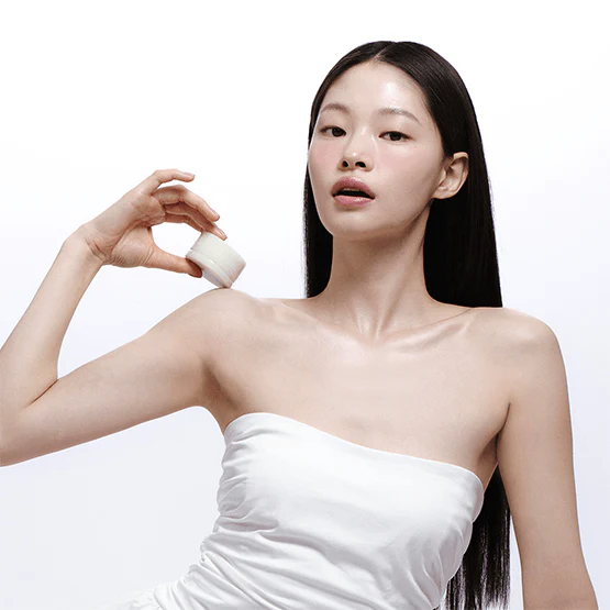 Model holding LADOR Body Multi Balm 30g against bare shoulder, showcasing beauty and skincare benefits.
