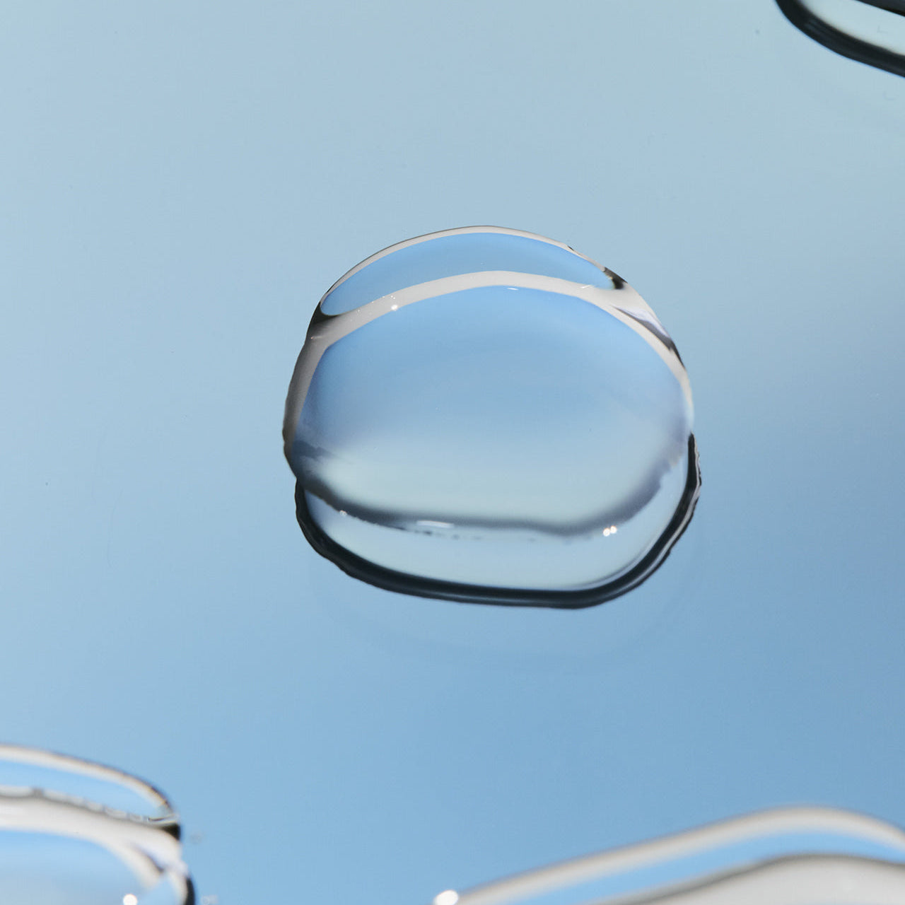 Close-up of liquid on surface, representing the LADOR Perfect Hair Fill-Up 150ml product texture and hydration benefits