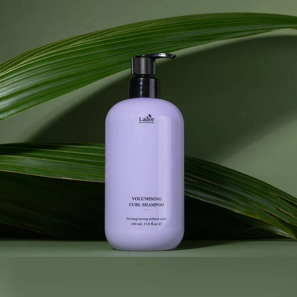 LADOR Volumizing Curl Shampoo 530ml bottle with green leaves background