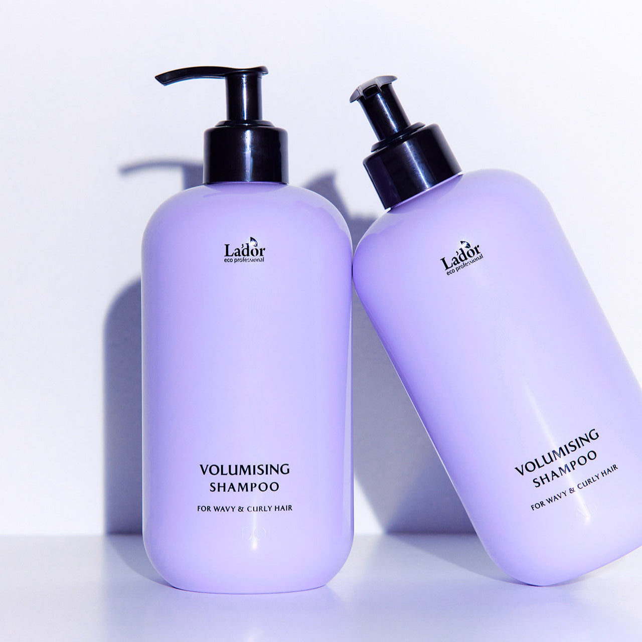 LADOR Volumizing Curl Shampoo 530ml for wavy and curly hair, purple bottle design with pump lid, enhances curls and adds volume.