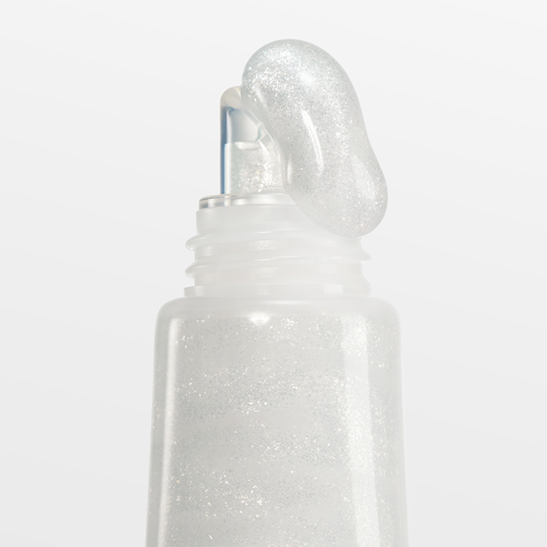 Close-up of LANEIGE Lip Glowy Balm (Milky Way/Pink Supernova) 10g showing the applicator and shimmering texture.
