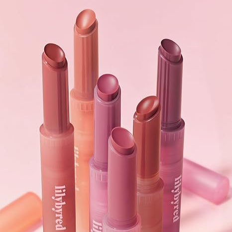 LILYBYRED Milky Blur Fondue Bar lipsticks in various shades against a pink background.
