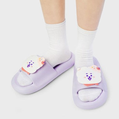 Person wearing LINE FRIENDS BT21 On The Cloud Edition Slippers in purple with cute character design.