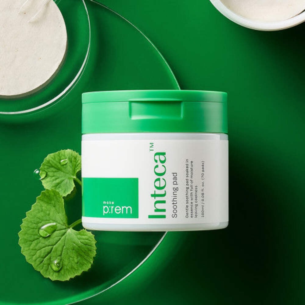 MAKE P:REM Inteca Trouble Soothing Pads 70 sheets container on green background with natural elements
