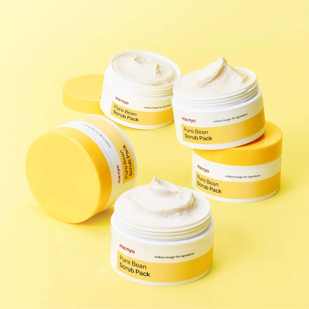 MANYO Pure Bean Scrub Pack 100ml jars on a yellow background, showcasing skincare product design and texture.