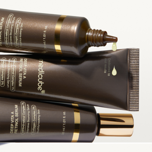 Three tubes of MEDICUBE Deep Vita A Retinol Serum 30ml with visible cream droplets.