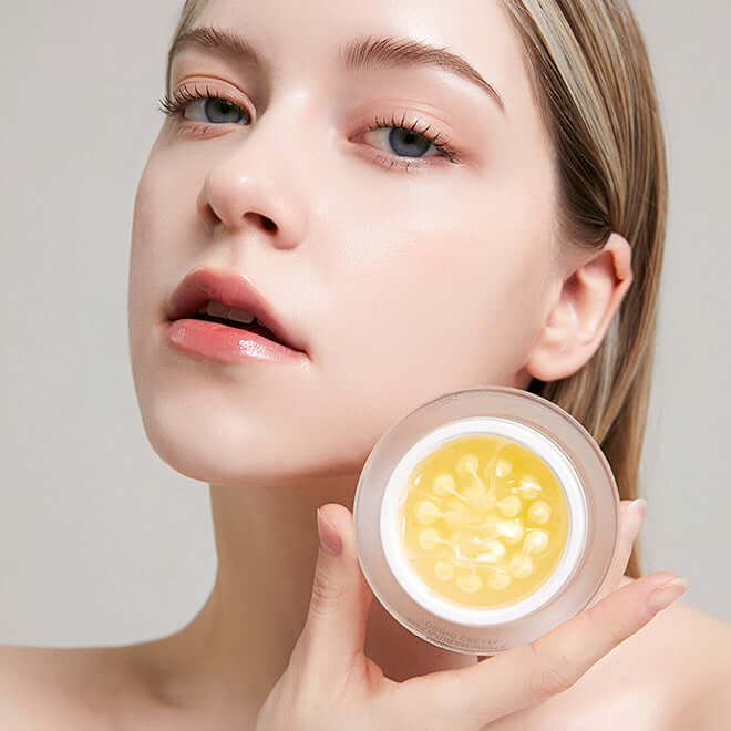 Person holding open container of skin cream
