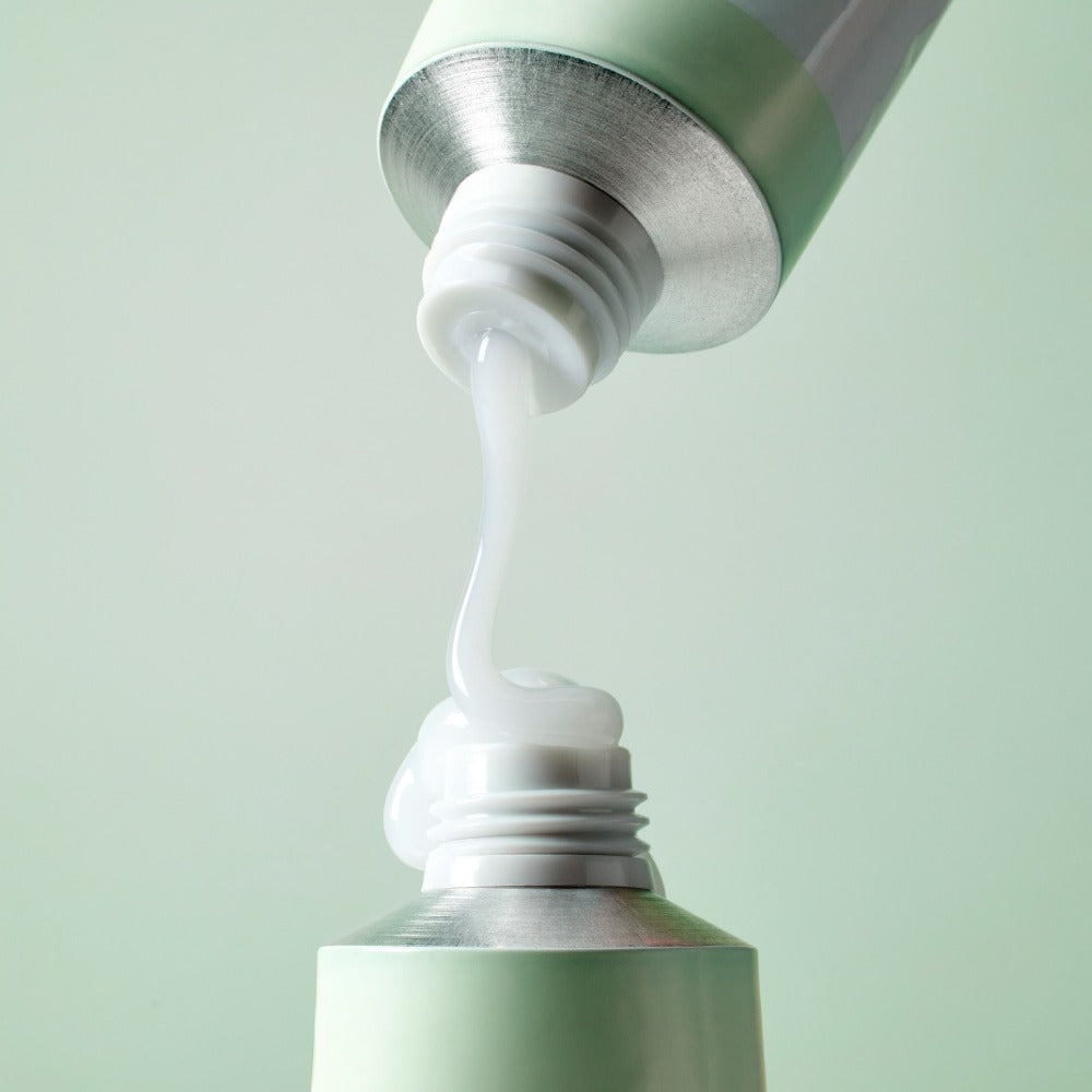 MIXSOON Cica Hyal Deep Soothing Cream 50ml being dispensed from tube in a close-up shot
