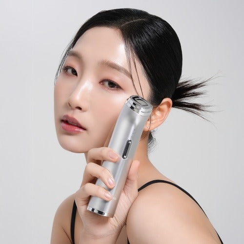 Woman using MIXSOON Derma Booster Pro for facial care