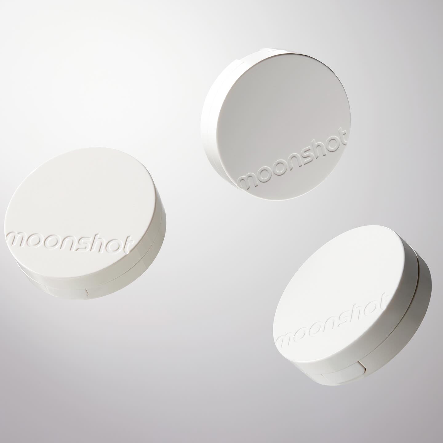 Image of three white cases of MOONSHOT Conscious Fit Glow Cushion Foundation.