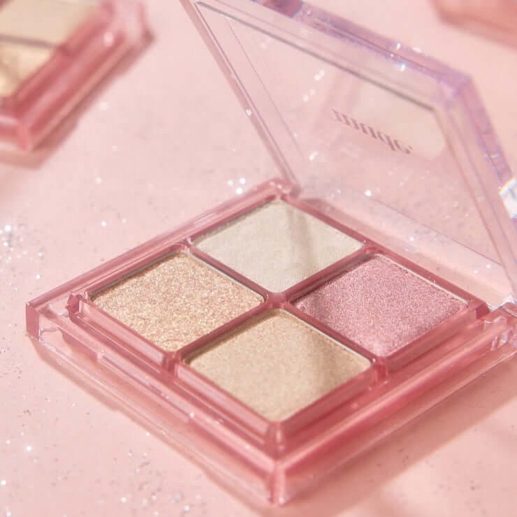MUDE Full bloom Glow Palette featuring four shimmer shades for a radiant makeup look, open display on a soft pink background.