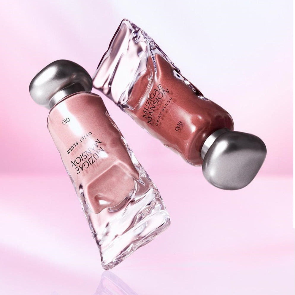 MUZIGAE MANSION Object Blush 5ml floating in artistic glass bottles against a soft pink background, highlighting luxury beauty product