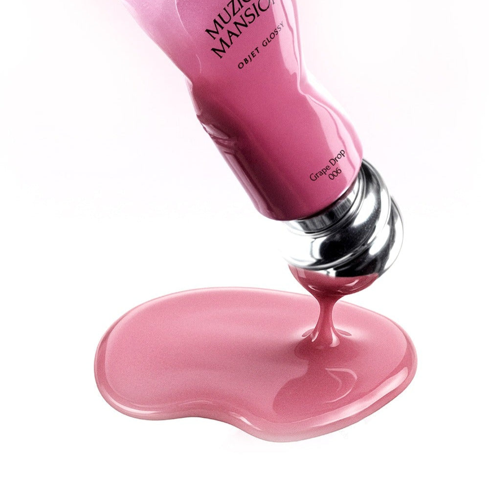 MUZIGAE MANSION Object Glossy pink tube pouring glossy liquid on surface