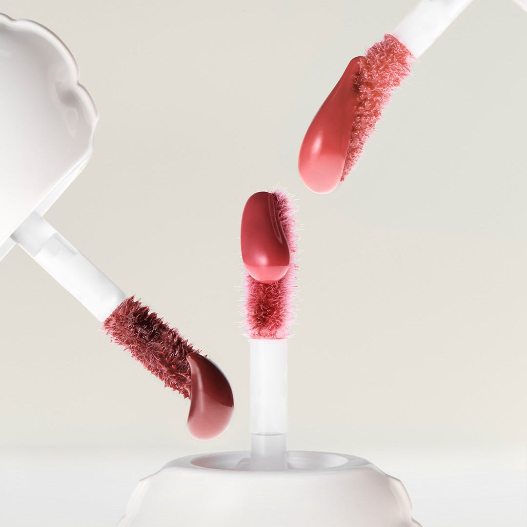 NAMING Glow Heart Lip Tint applicators with vibrant color swatches on a neutral background.