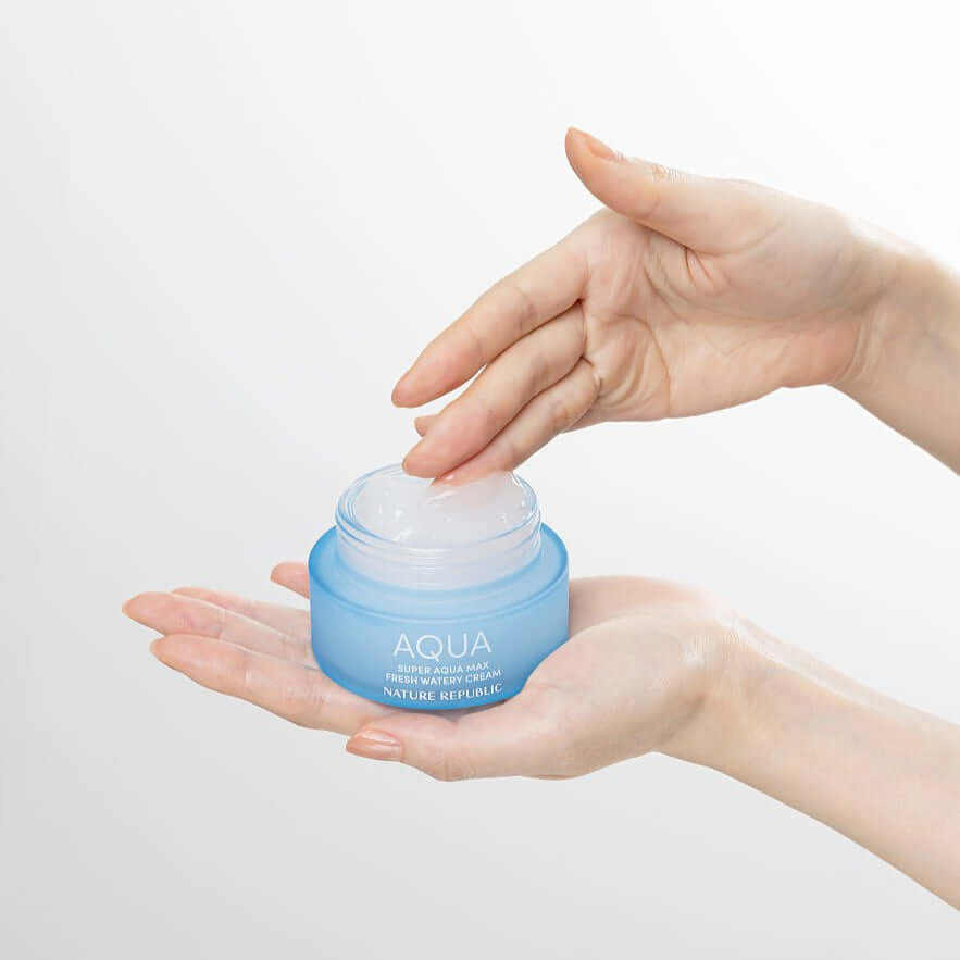 NATURE REPUBLIC Super Aqua Max Fresh Watery Cream 80ml held in hands, showcasing texture and packaging.