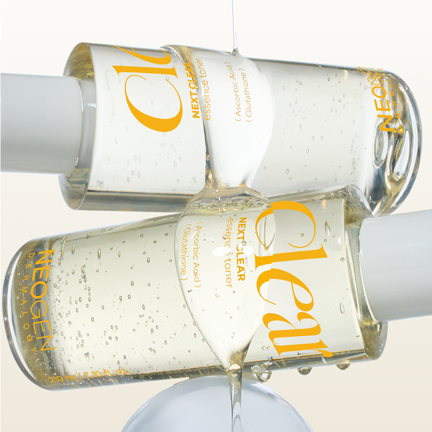 Two bottles of NEOGEN Next Clear Essence Toner 210ml with clear liquid, showcasing skincare product design and texture.