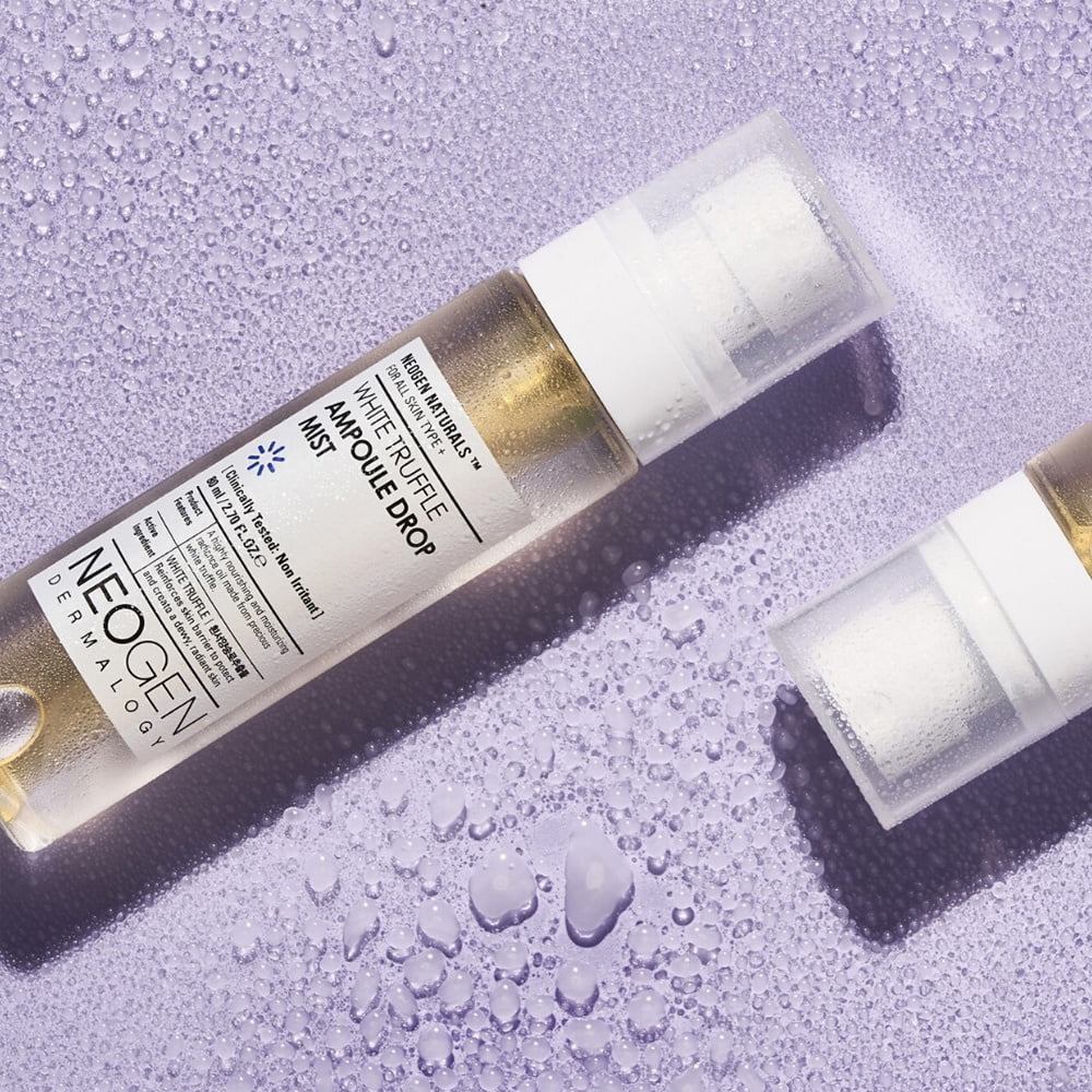 Image of NEOGEN White Truffle Ampoule Drop Mist 80ml bottle on a purple background with water droplets.
