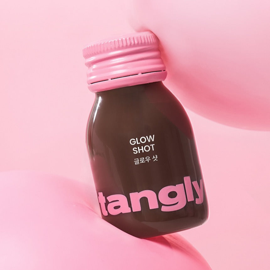 NOTHING BETTER Tangly Glow Shot 7 Bottles on pink background, highlighting the bottle design and vibrant colors.