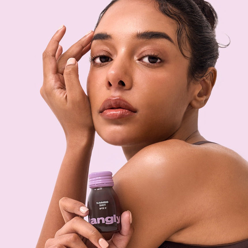 Woman holding NOTHING BETTER Tangly Slimming Shot 7 Bottles close-up, promoting its benefits and effectiveness.
