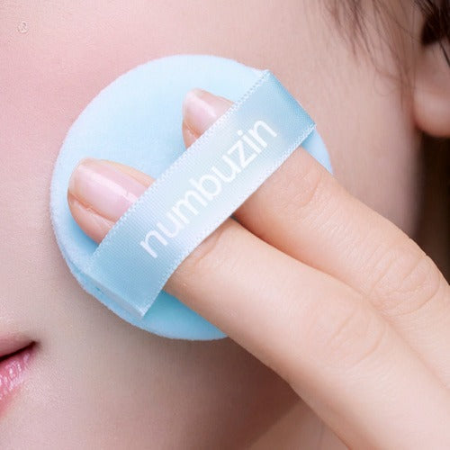 Close-up of a person using NUMBUZIN No.1 Pantothenic Acid Skincare 100 Blur Powder 7g with puff applicator.