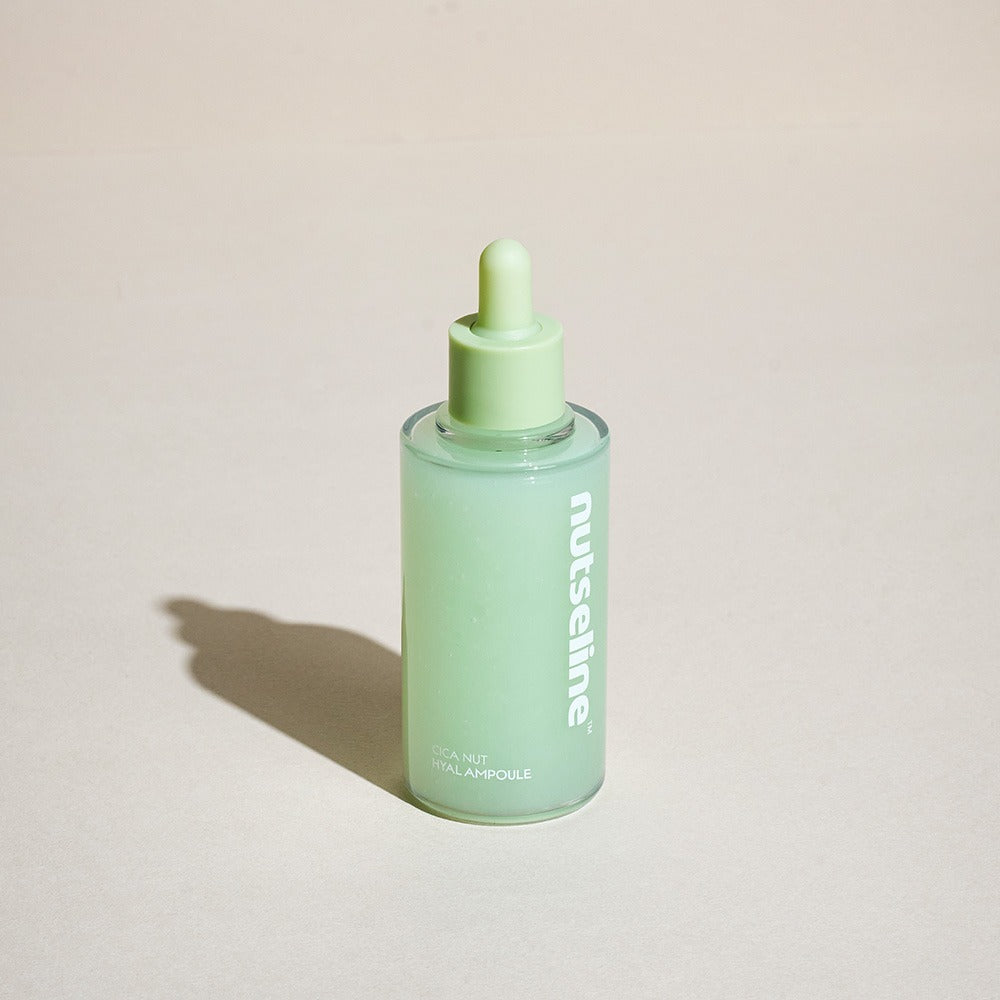 NUTSELINE Cica Nut Hyal Ampoule 90ml green bottle on a neutral background