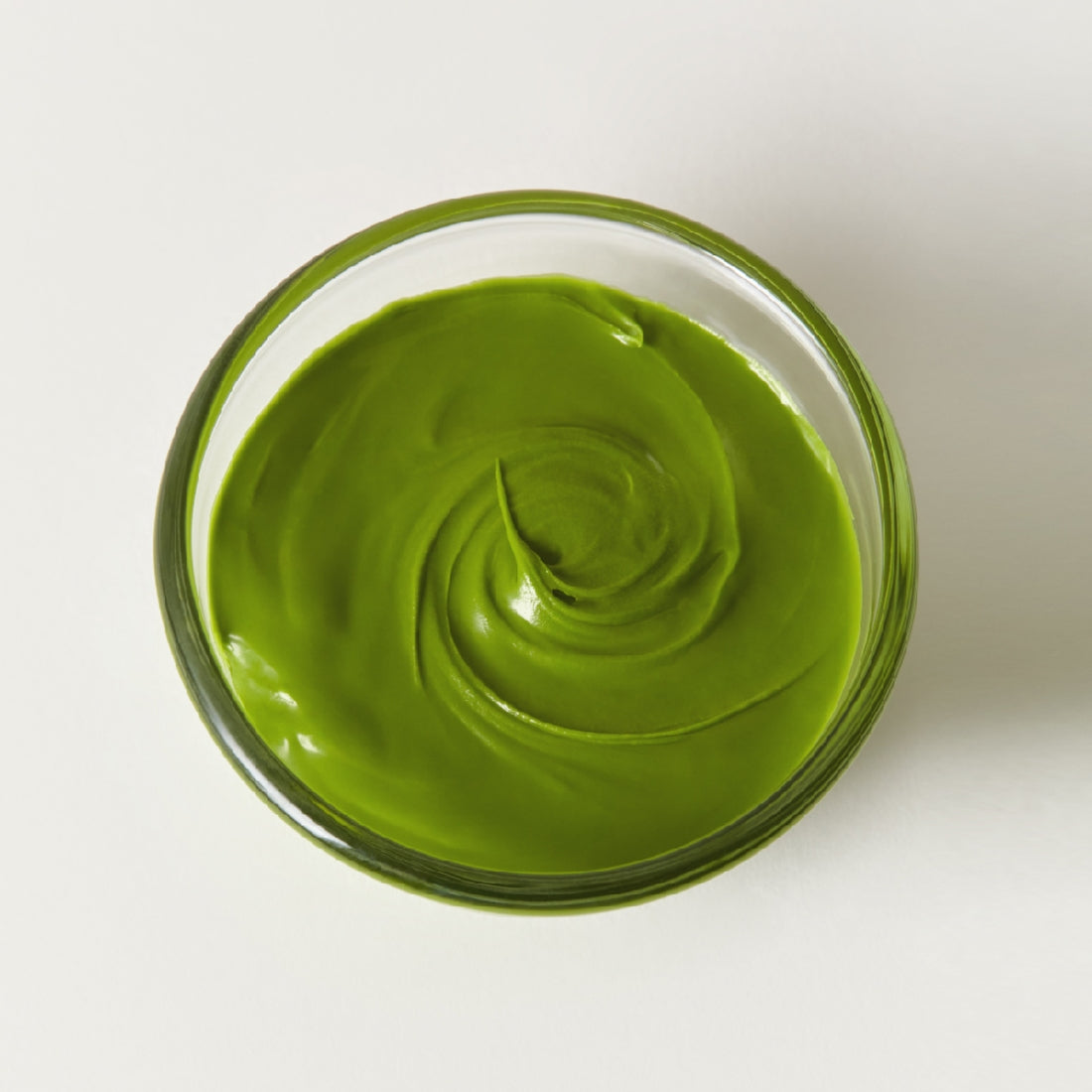 Glass bowl with OSULLOC Green Tea Milk Spread 200g, vibrant green color, creamy texture, ideal for diverse culinary applications.