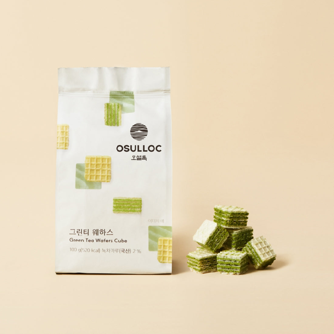 OSULLOC Green Tea Wafers 100g pack with green and cream-colored wafers next to bag on beige background