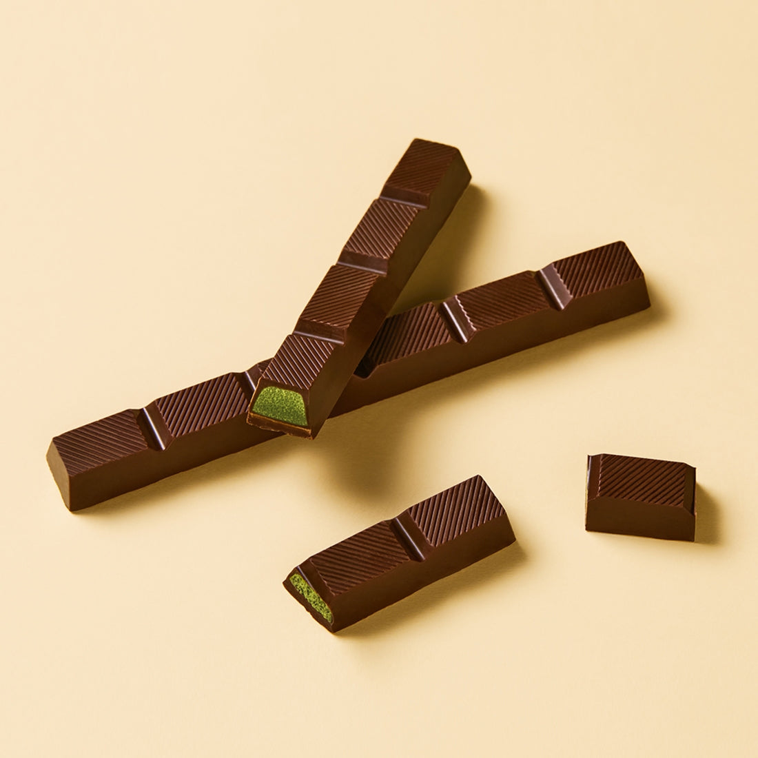 OSULLOC Jeju Island Green Tea Chocolate Bar 120g on beige background, showing green tea filling and rich chocolate texture.