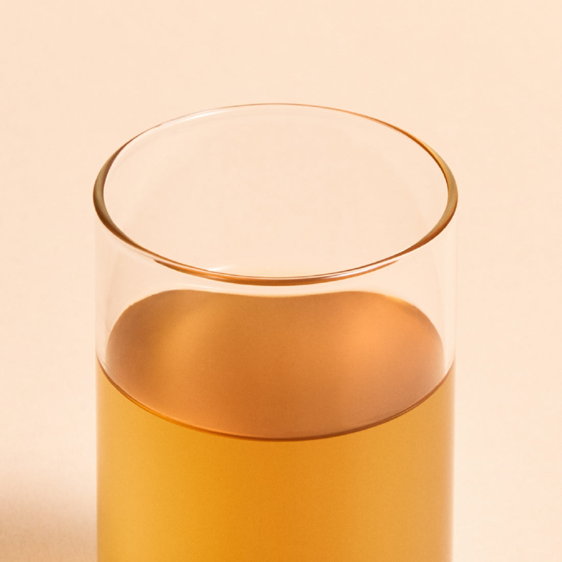 Glass of OSULLOC Jeju Volcanic Oolong Tea 20 P with a warm amber color, showcasing premium tea quality.