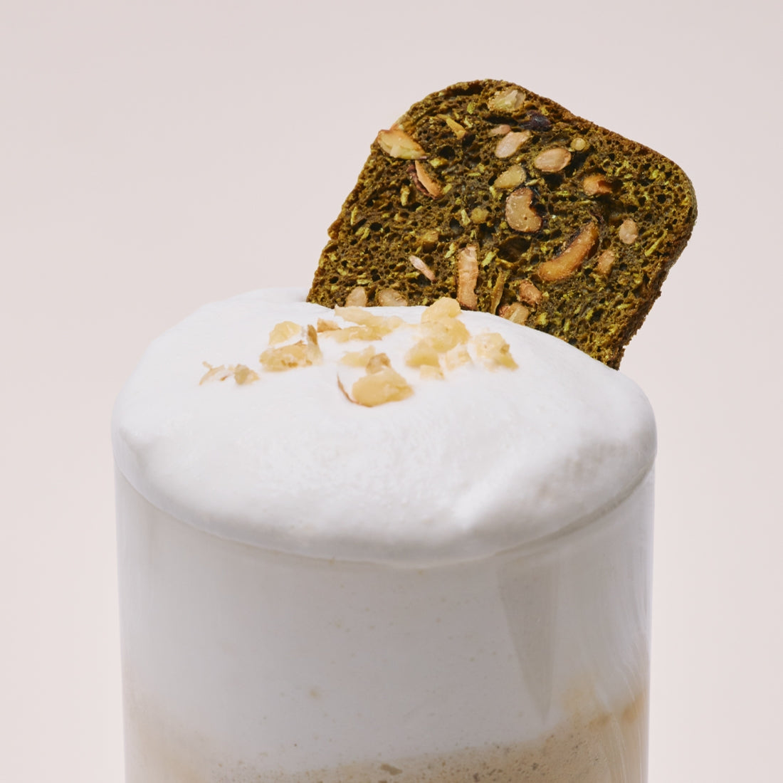 OSULLOC Matcha Biscotti Chips 100g garnishing a creamy beverage topped with nuts